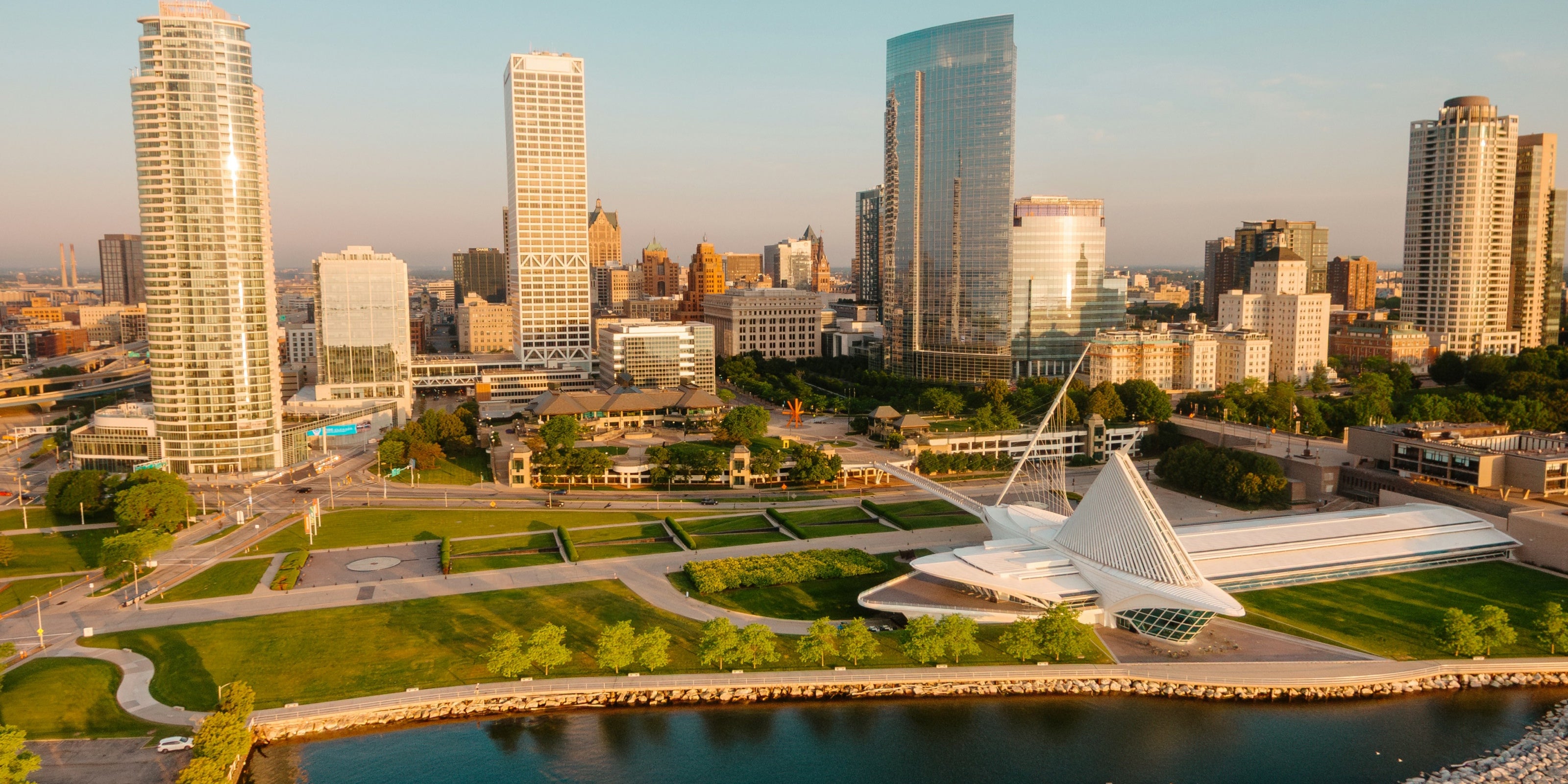 Milwaukee Downtown Cityscape with modern buildings and a prominent sculpture by the waterfront. Photo by Tom Barrett on Unsplash
